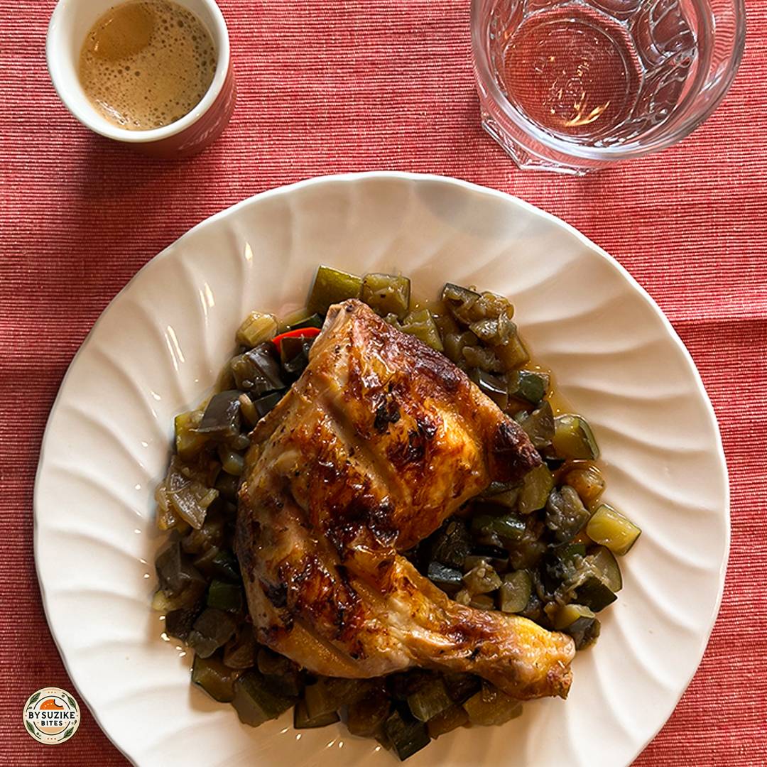 Low carb meal idea with roasted chicken leg served over sautéed zucchini and eggplant.