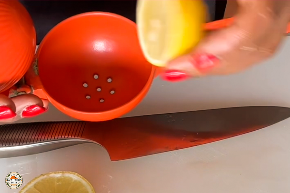 Step 2: Squeezing fresh lemon juice over the pork before seasoning
