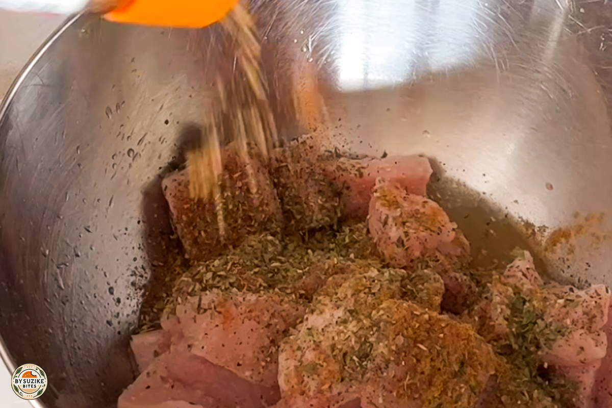 Step 4: Mixing spices into the pork to season it evenly
