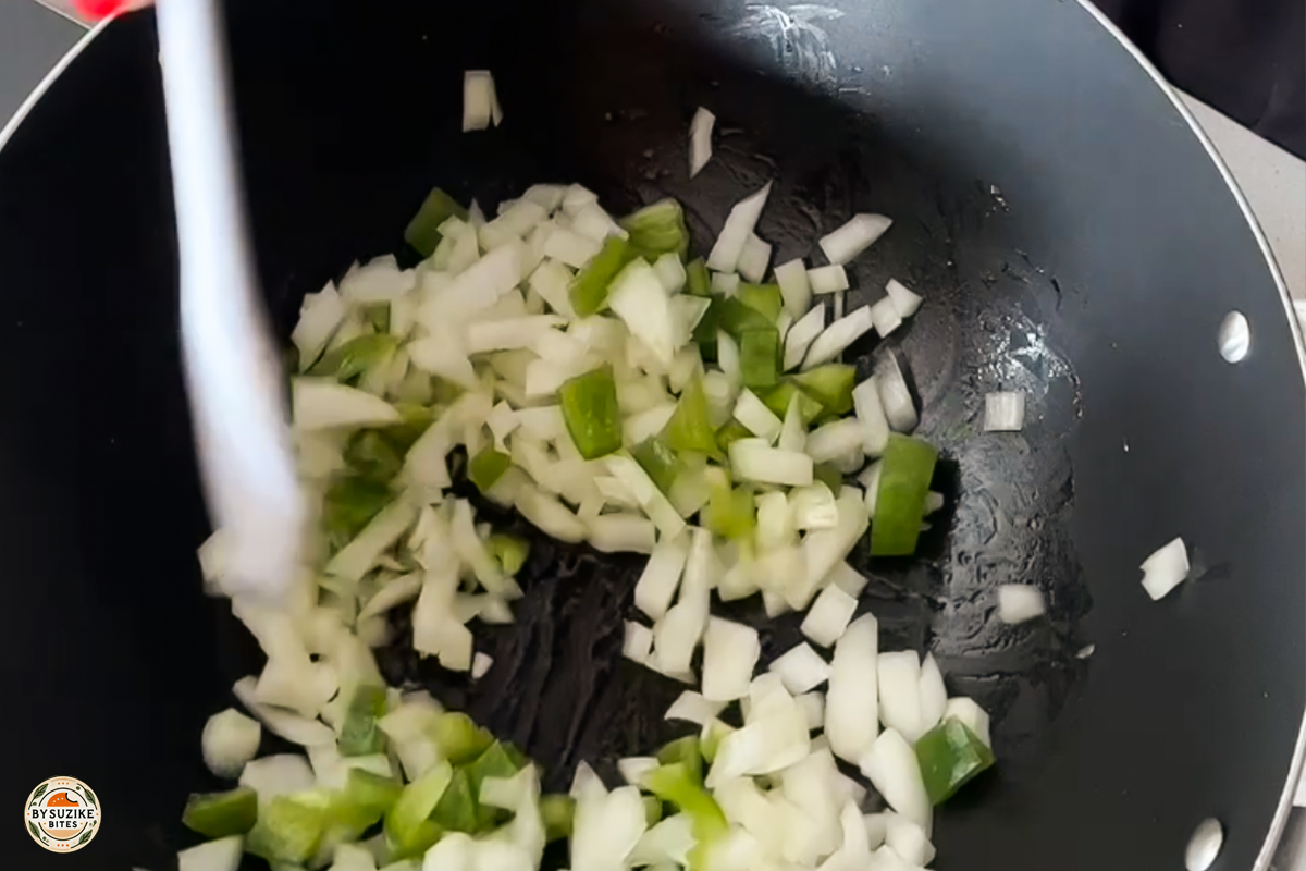 Step 9: Sautéing chopped onion and green pepper in a pan
