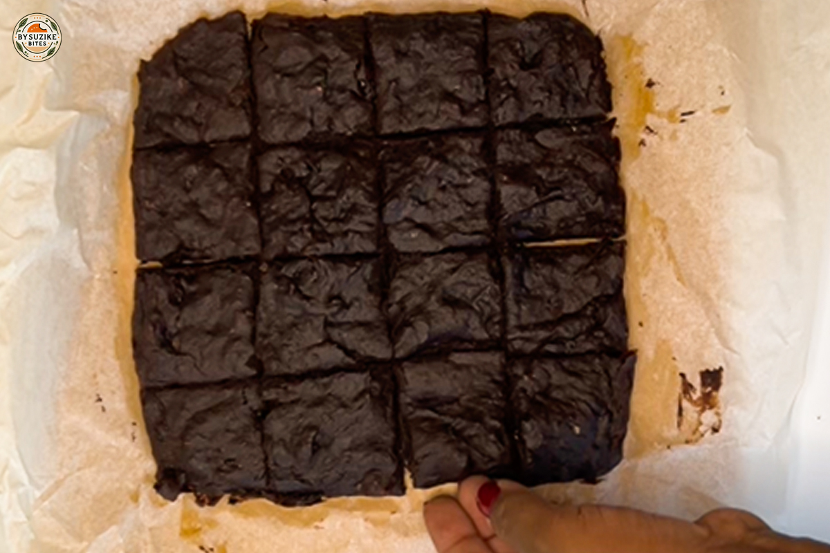 Baked vegan banana brownies sliced into squares in the pan.