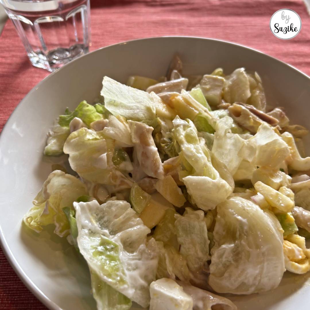 what i eat in a day creamy pasta salad bowl with leafy greens, cucumber, apple, egg, and dressing