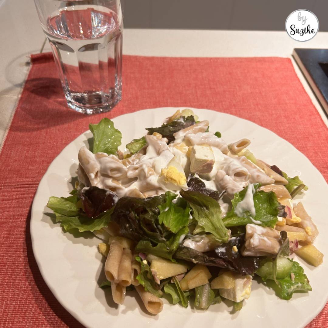 what i eat in a day pasta salad plate with mixed greens, pasta, egg, and creamy dressing