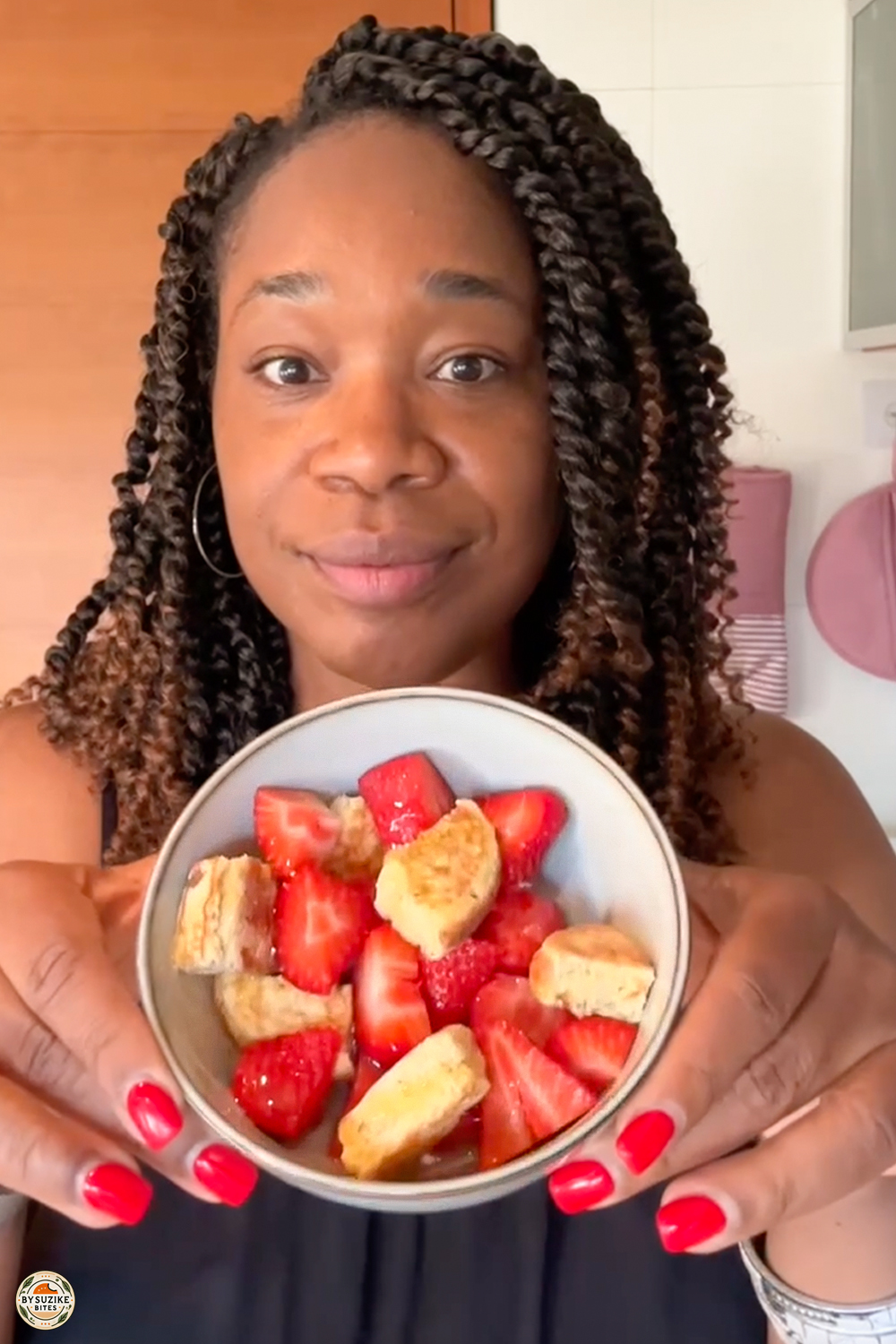 Easy healthy recipes thumbnail with woman holding a bowl of strawberries and banana slices in a bright kitchen.