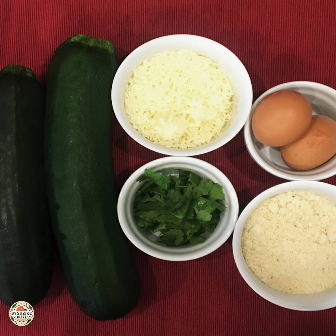 Ingredients for keto zucchini tots: zucchini, mozzarella, eggs, almond flour and herbs.