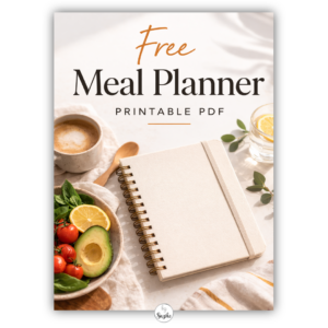 Flat lay cover image for a free meal planner printable PDF with a healthy bowl, avocado, coffee, orange juice, pen and wooden spoon on a clean white background.
