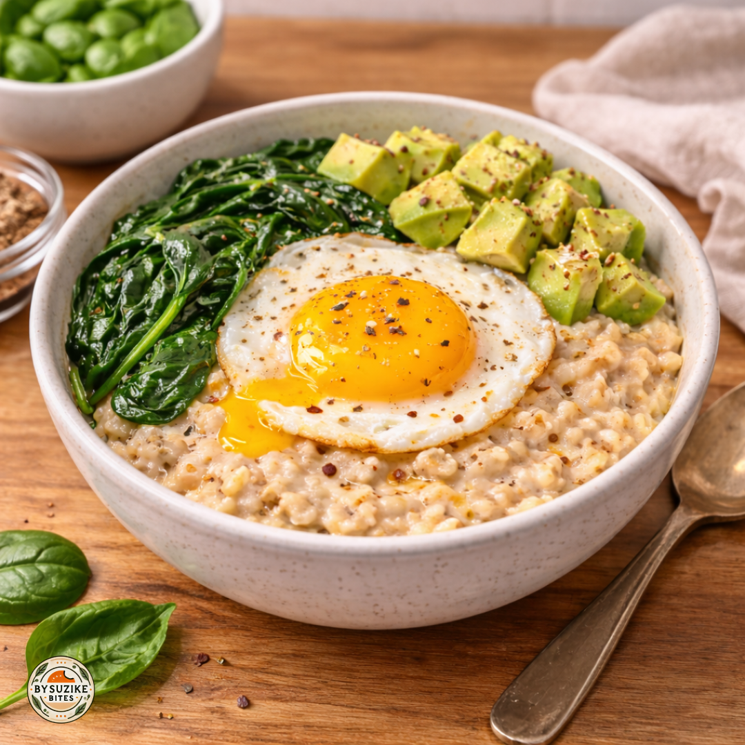Savory oats with egg and spinach in a bowl on a wooden kitchen counter