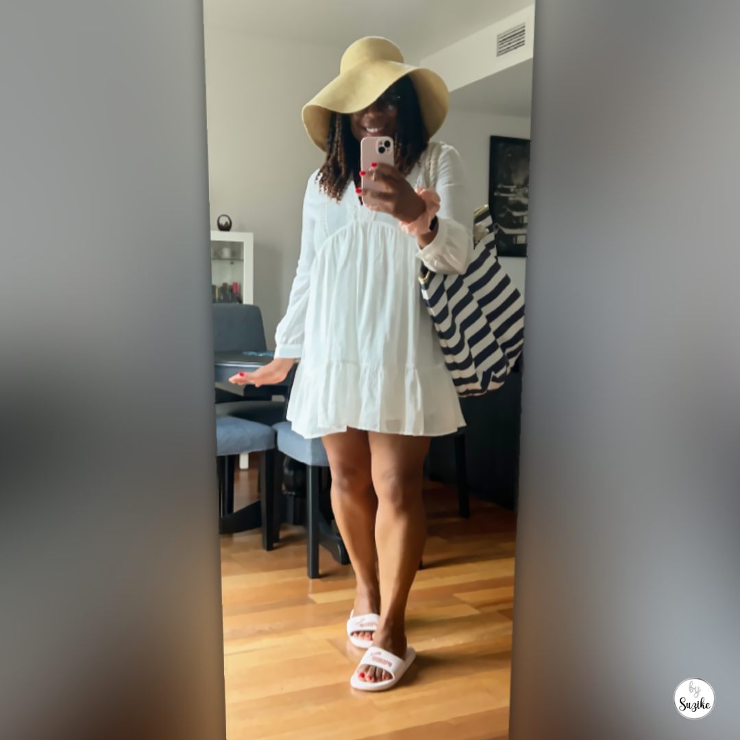 beach-outfit-with-summer-hat-white-dress-02 Beach outfit with summer hat featuring a white flowy dress striped beach bag and oversized sunglasses