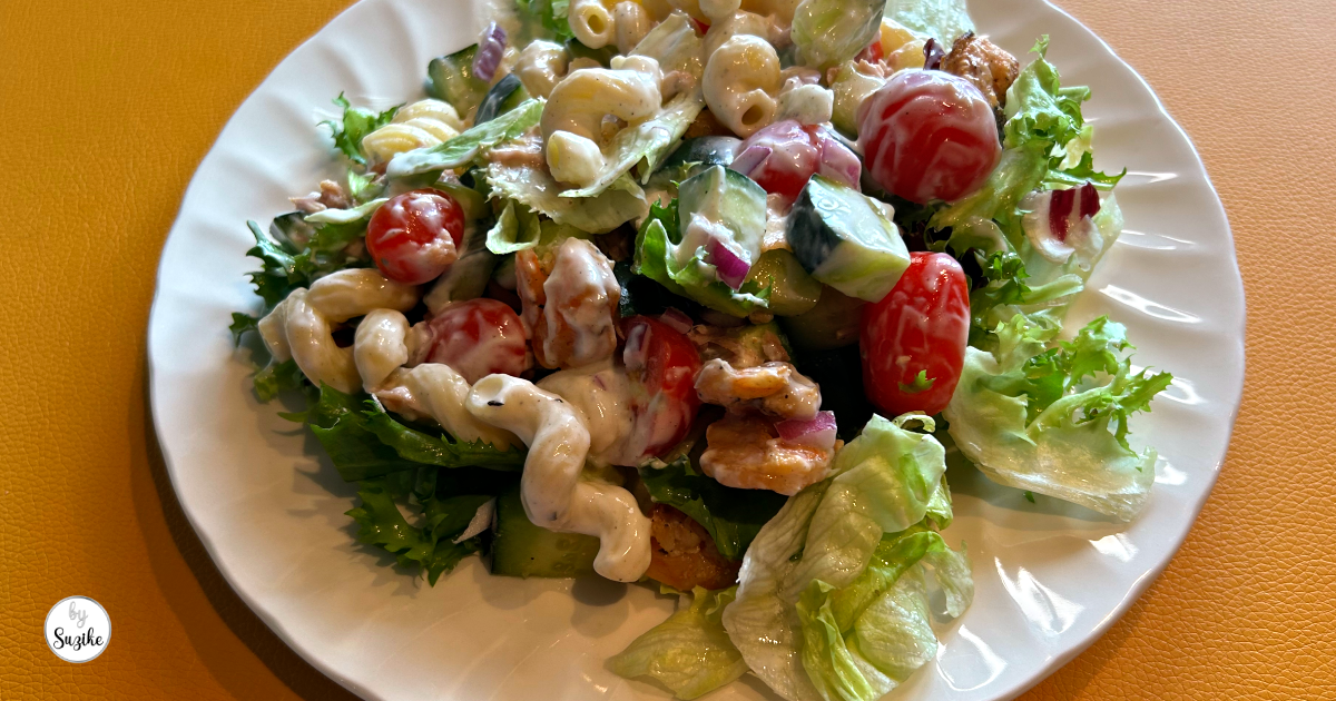 Fresh meal prep jar salad served on a plate after being poured from a glass jar.