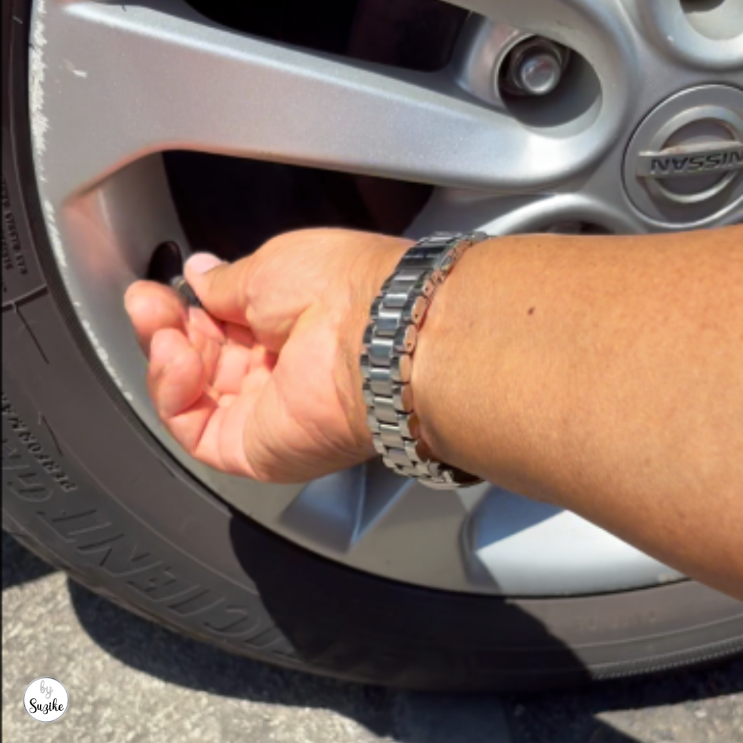 removing-tire-valve-cap-portugal Removing the tire valve cap before checking tire pressure at a gas station