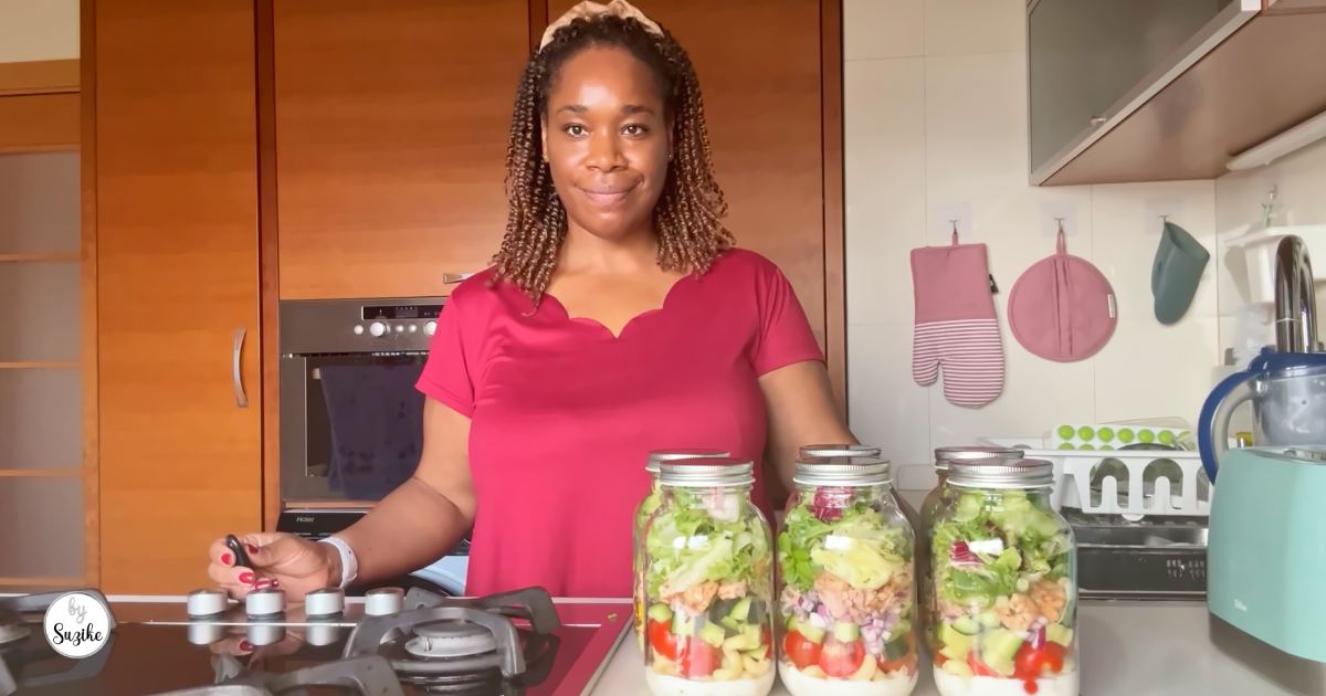 Six meal prep jar salads prepared for the week with fresh vegetables, chicken, tuna, shrimp and greens.