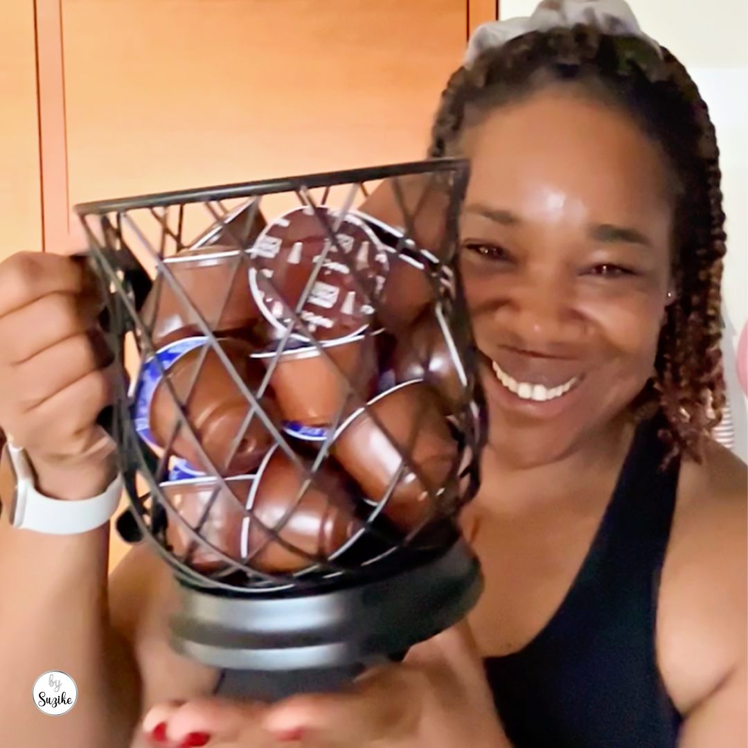 Suzike holding the black metal coffee pod holder she has used for over two years
