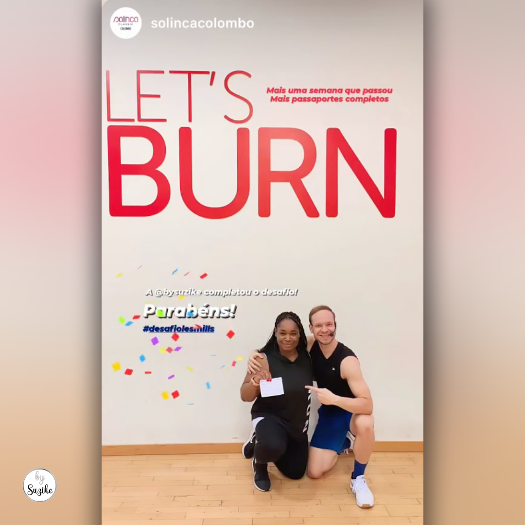 "Suzike smiling and holding up her stamped Les Mills Passport after completing the challenge"